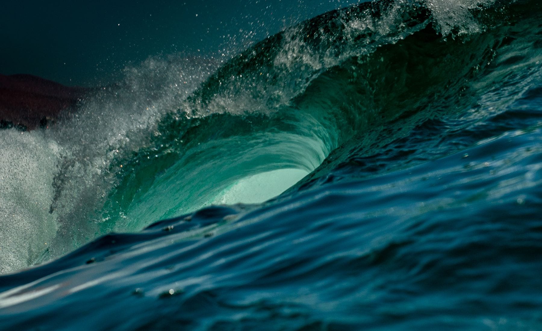 A surfer riding a wave off the Bolinas coast